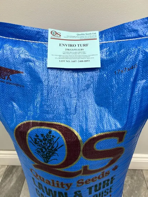 A blue 25kg bag of Enviro Turf seeds from Quality Seeds Ltd., designed for lawn and turf grass, is pictured against a simple indoor background.
