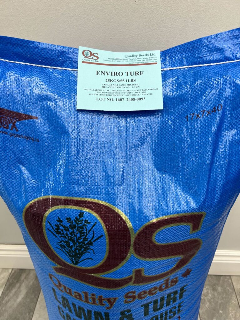 A blue 25kg bag of Enviro Turf seeds from Quality Seeds Ltd., designed for lawn and turf grass, is pictured against a simple indoor background.